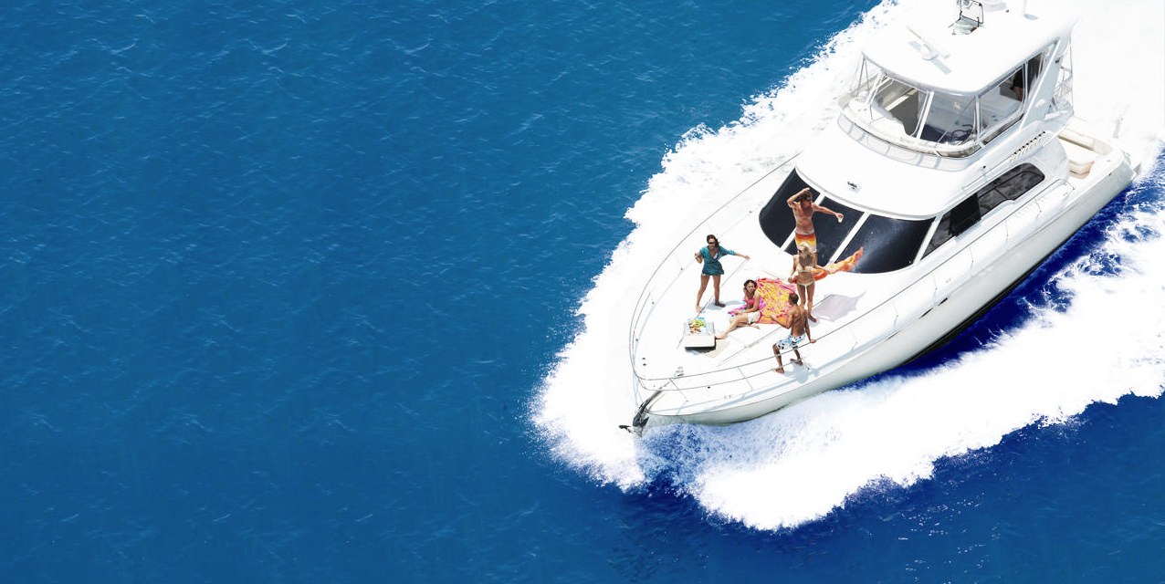 People enjoying their time on a luxury yacht boating through the ocean.